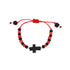 The Genuine Azabache Bracelet for Baby, featuring an adjustable red cord with alternating black and red beads, provides spiritual protection. A striking black cross-shaped bead is at the center, while small black beads elegantly finish the ends, making it ideal for safeguarding little ones.
